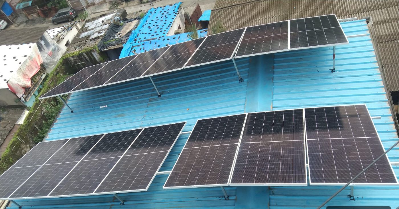 Solar panels on a metal-sheet roof in Ulhasnagar
